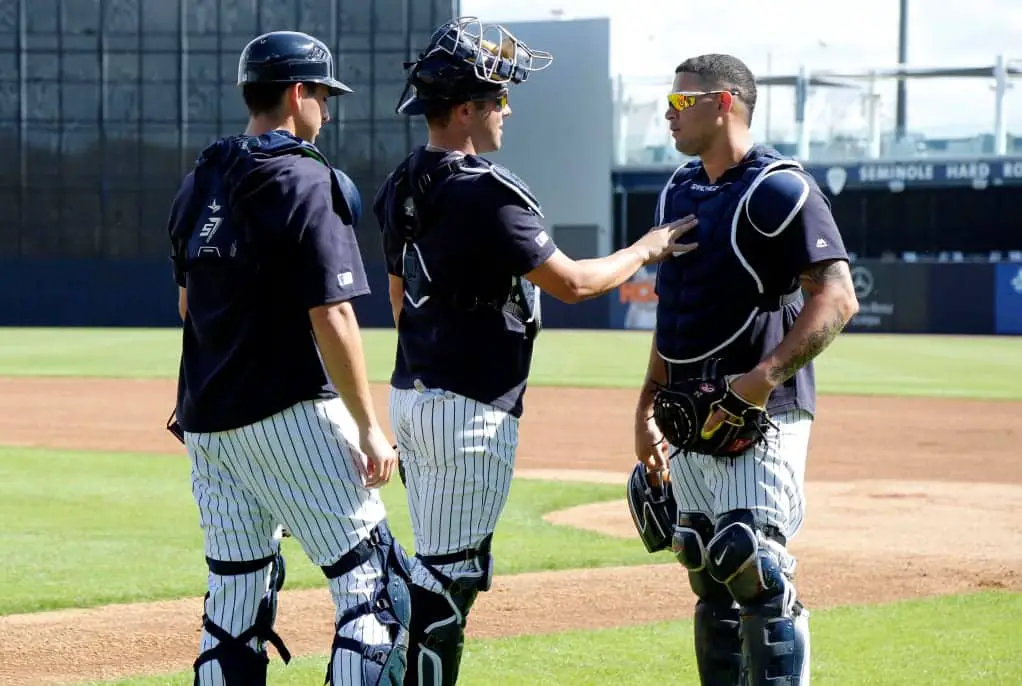 Kyle Higashioka, Austine Romine and Gary Sanchez talking during Yankees spring training